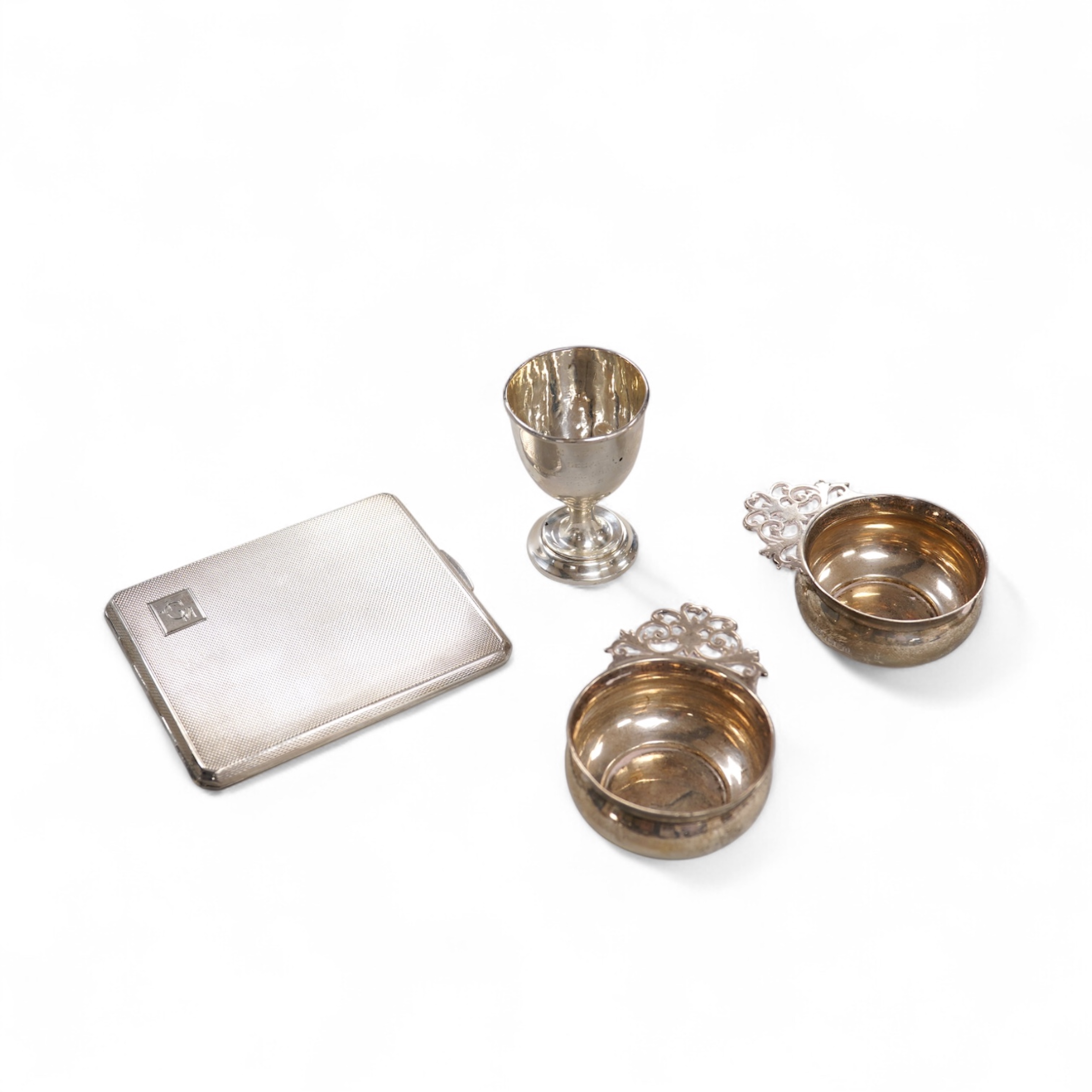 A George V engine turned silver cigarette case by Smith & Bartlam, Birmingham, 1921, a pair of Edwardian silver single handled small dishes by Goldsmiths & Silversmiths Co Ltd and a silver egg cup.